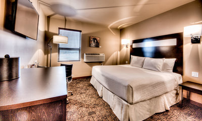 Large King Bed in King Bachelor Room at Podollan Inn & Spa Grande Prairie